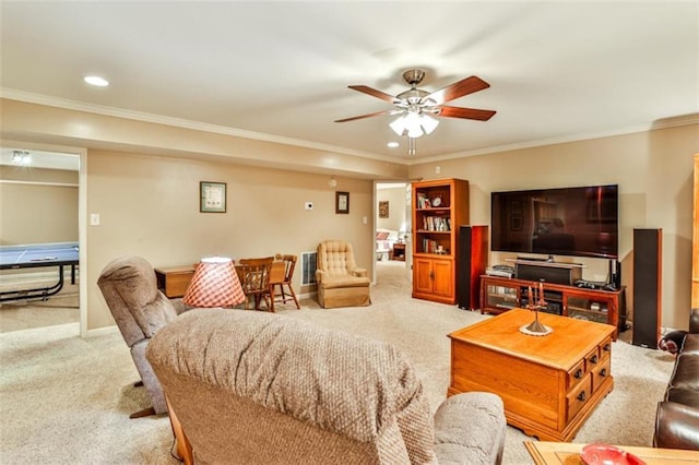 carpeted living room featuring crown molding and ceiling fan