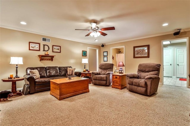 living room with ceiling fan, ornamental molding, and carpet floors