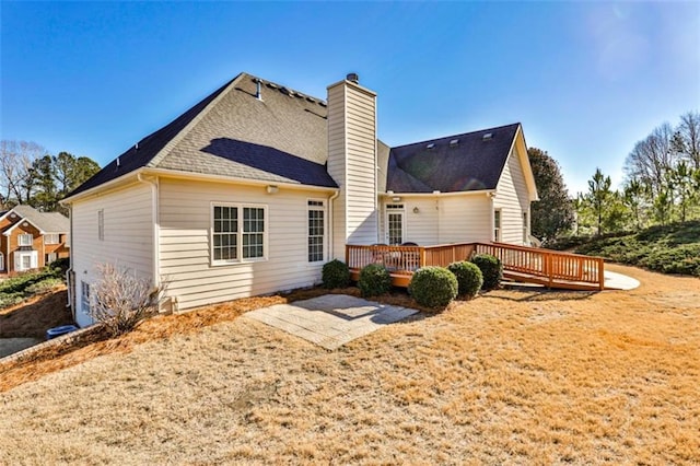 rear view of house with a patio and a deck