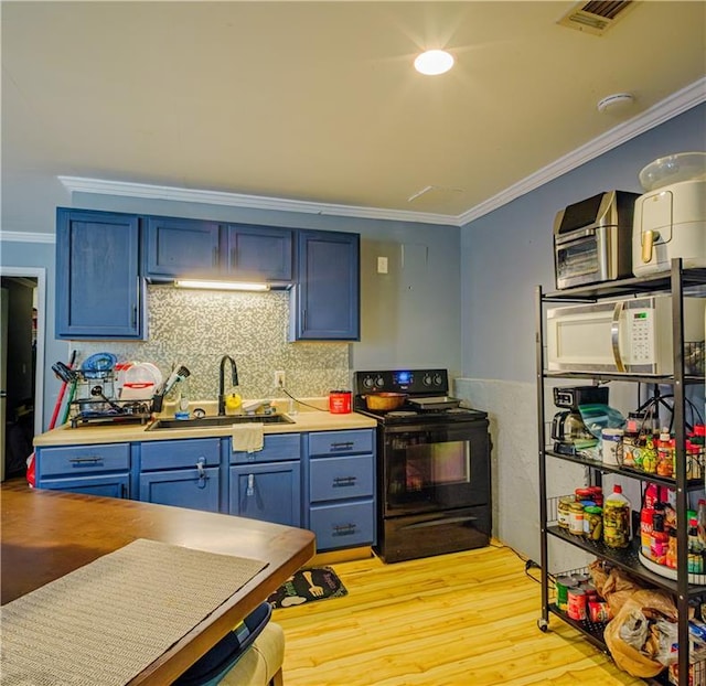 1444 Elliotts Ln, Auburn, GA 30011 - kitchen with black electric range, blue cabinets, white microwave, crown molding, and light wood finished floors