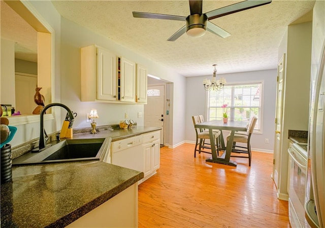 1444 Elliotts Ln, Auburn, GA 30011 - kitchen featuring a sink, white electric stove, light wood-type flooring, a chandelier, and hanging light fixtures