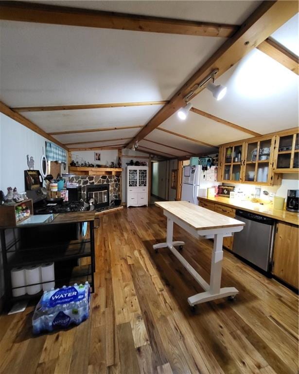 kitchen featuring hardwood / wood-style floors, lofted ceiling with beams, dishwasher, and white refrigerator