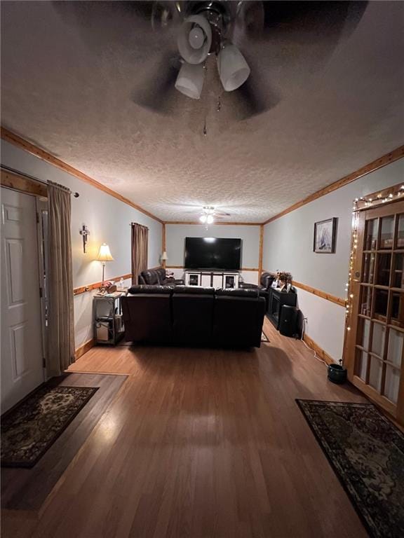 bedroom featuring ornamental molding, a textured ceiling, and hardwood / wood-style floors