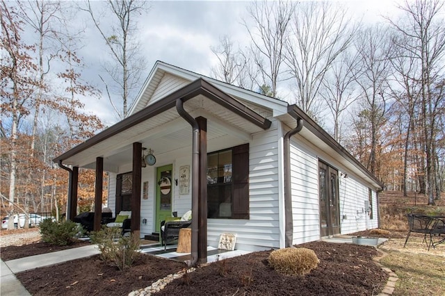 view of side of property with covered porch