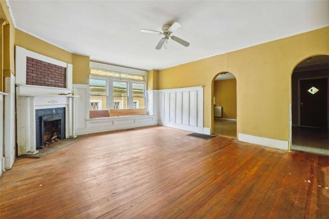 unfurnished living room featuring ceiling fan and hardwood / wood-style flooring