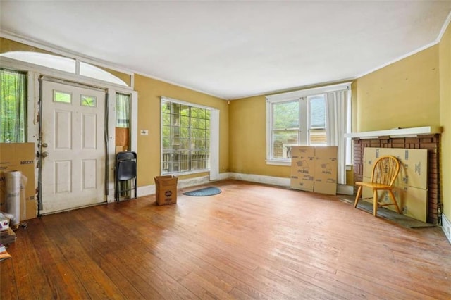 foyer entrance featuring wood-type flooring and ornamental molding