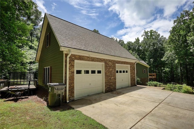 116 Woolsey Creek Trl, Fayetteville, GA 30215 - view of side of property with concrete driveway, a shingled roof, and a garage
