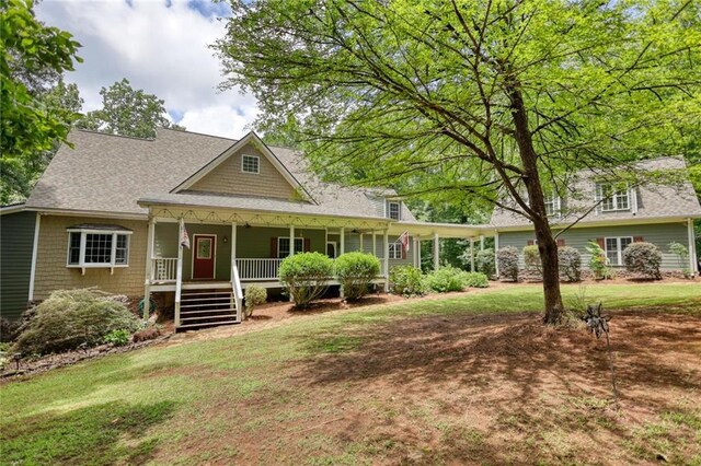 116 Woolsey Creek Trl, Fayetteville, GA 30215 - view of front of home with a porch, a front yard, roof with shingles, and stairway