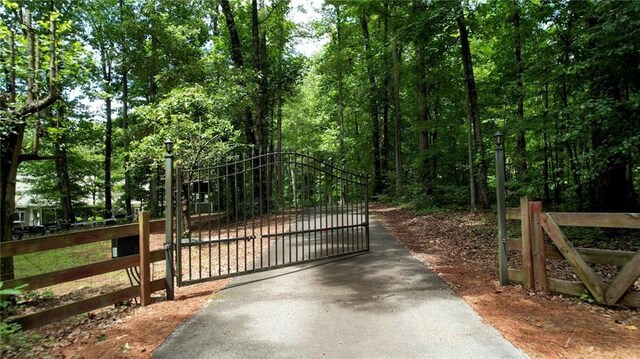 116 Woolsey Creek Trl, Fayetteville, GA 30215 - gate featuring fence and a view of trees