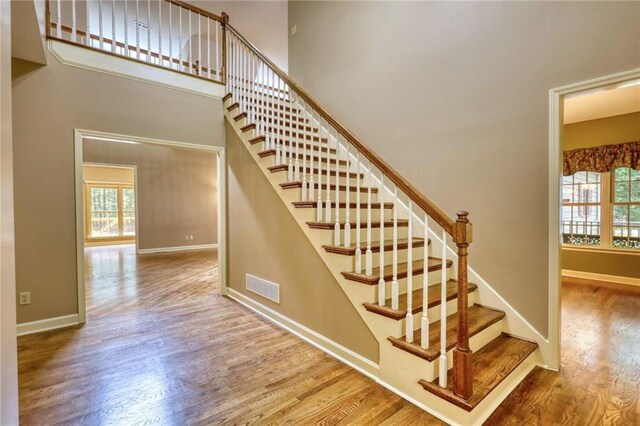 116 Woolsey Creek Trl, Fayetteville, GA 30215 - staircase featuring healthy amount of natural light, wood finished floors, baseboards, and a towering ceiling