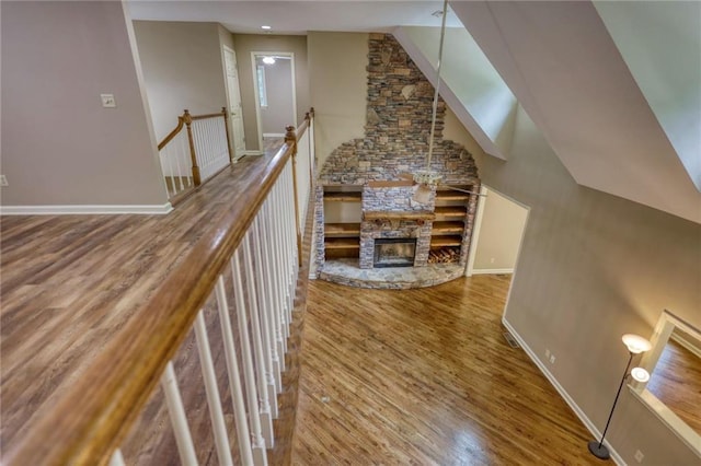 116 Woolsey Creek Trl, Fayetteville, GA 30215 - unfurnished living room with wood finished floors, vaulted ceiling, baseboards, and a fireplace