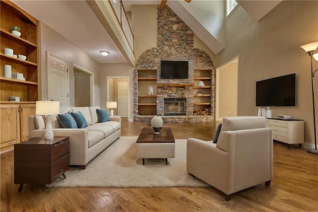 116 Woolsey Creek Trl, Fayetteville, GA 30215 - living area with a high ceiling, wood finished floors, built in features, a fireplace, and baseboards