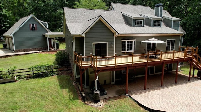 116 Woolsey Creek Trl, Fayetteville, GA 30215 - back of property with a wooden deck, a patio, a shingled roof, and a chimney
