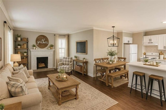 15 Harlan Rd, Atlanta, GA 30311 - living area with dark wood-style floors, crown molding, baseboards, a fireplace, and a chandelier