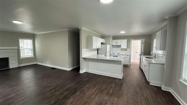 15 Harlan Rd, Atlanta, GA 30311 - kitchen featuring white appliances, a sink, dark wood-style flooring, light countertops, and a peninsula