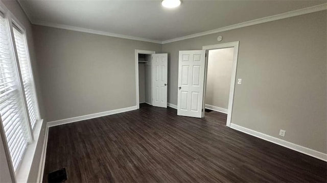 15 Harlan Rd, Atlanta, GA 30311 - unfurnished bedroom featuring dark wood-style flooring, baseboards, crown molding, and a closet