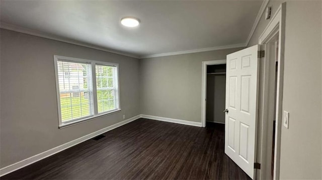 15 Harlan Rd, Atlanta, GA 30311 - unfurnished bedroom with baseboards, dark wood-style floors, ornamental molding, and a closet