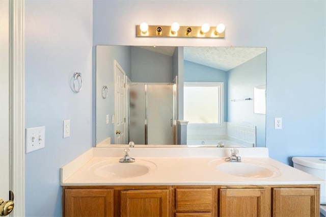 bathroom with a bath, a stall shower, vaulted ceiling, and a sink