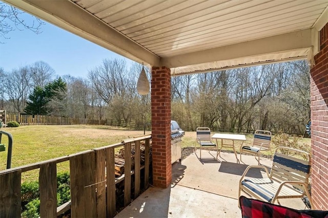 view of patio with exterior kitchen and a fenced backyard