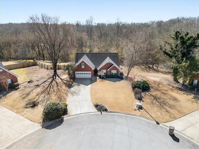 birds eye view of property with a wooded view