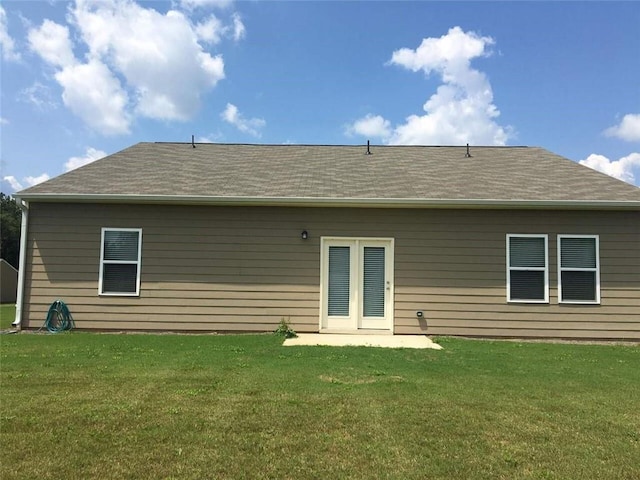 rear view of house with a yard