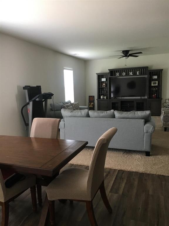 dining space with hardwood / wood-style flooring and ceiling fan