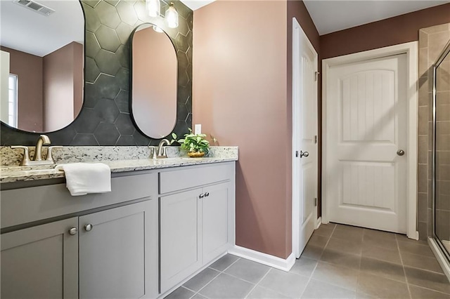 108 Wildflower Trce, Dallas, GA 30132 - full bath featuring a shower with door, tile patterned floors, double vanity, and baseboards
