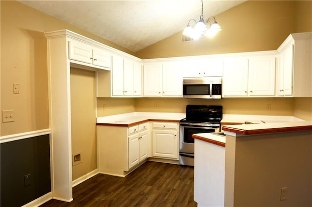 kitchen featuring lofted ceiling, decorative light fixtures, appliances with stainless steel finishes, a notable chandelier, and white cabinets