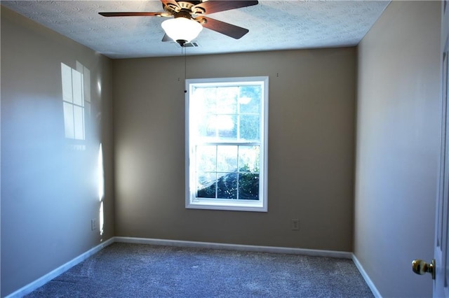 carpeted empty room featuring ceiling fan and a textured ceiling