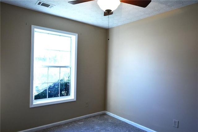 empty room with ceiling fan and carpet flooring