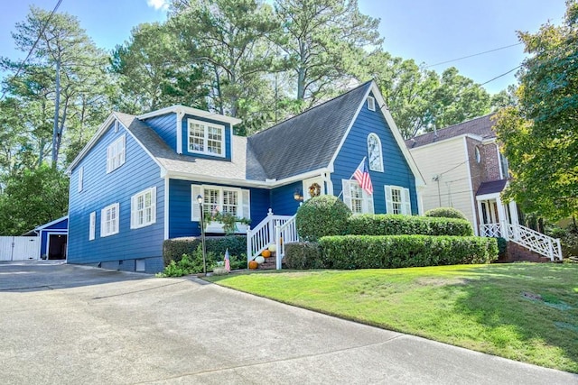 2195 Edison Ave NE, Atlanta, GA 30305 - view of front of home with a shingled roof, a front lawn, and an outbuilding