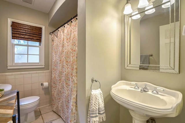 2195 Edison Ave NE, Atlanta, GA 30305 - bathroom featuring a sink, toilet, tile walls, visible vents, and tile patterned flooring