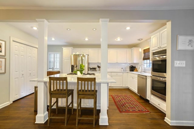 2195 Edison Ave NE, Atlanta, GA 30305 - kitchen with a sink, dark wood finished floors, white cabinetry, and appliances with stainless steel finishes