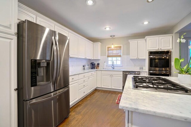 2195 Edison Ave NE, Atlanta, GA 30305 - kitchen featuring a sink, white cabinetry, dark wood-type flooring, and appliances with stainless steel finishes