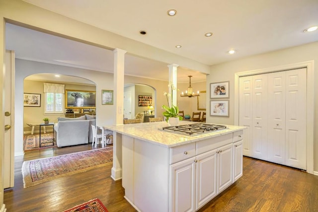 2195 Edison Ave NE, Atlanta, GA 30305 - kitchen featuring stainless steel gas stovetop, white cabinetry, open floor plan, arched walkways, and dark wood-style floors