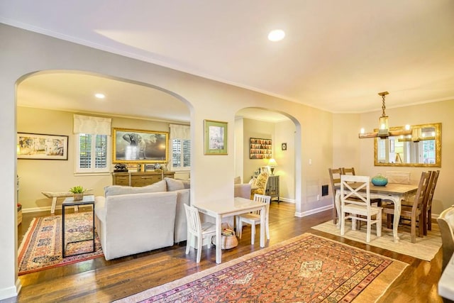 2195 Edison Ave NE, Atlanta, GA 30305 - living room with wood finished floors, crown molding, baseboards, arched walkways, and recessed lighting