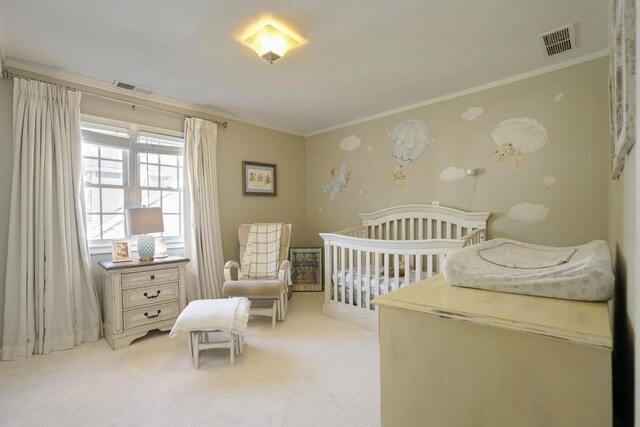 2195 Edison Ave NE, Atlanta, GA 30305 - bedroom featuring ornamental molding, light carpet, a nursery area, and visible vents