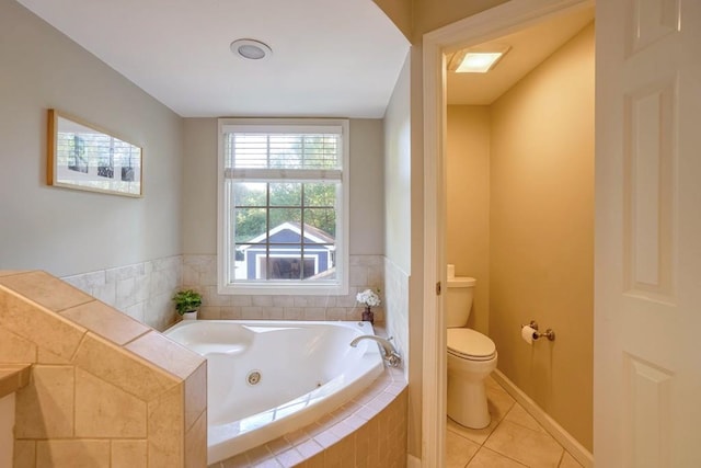 2195 Edison Ave NE, Atlanta, GA 30305 - bathroom featuring toilet, a tub with jets, tile patterned flooring, and baseboards