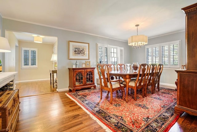 2195 Edison Ave NE, Atlanta, GA 30305 - dining space featuring baseboards, ornamental molding, a chandelier, and wood finished floors