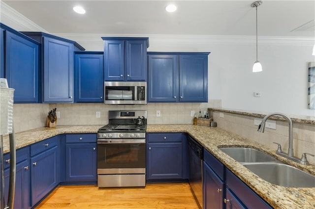 kitchen featuring blue cabinetry, stainless steel appliances, and a sink