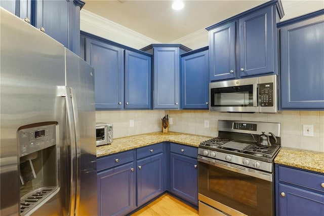 kitchen with tasteful backsplash, blue cabinetry, light stone countertops, ornamental molding, and stainless steel appliances