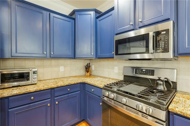 kitchen with blue cabinets, ornamental molding, backsplash, stainless steel appliances, and a toaster