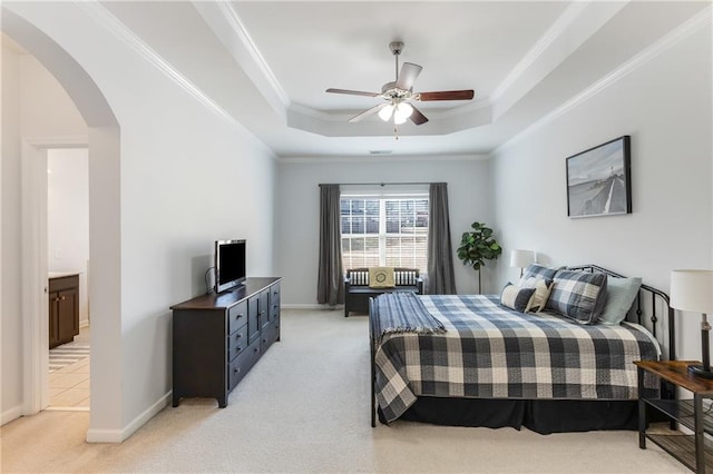 bedroom with light carpet, arched walkways, a raised ceiling, and ornamental molding