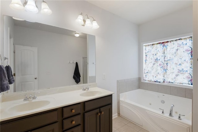 bathroom featuring tile patterned flooring, double vanity, a whirlpool tub, and a sink