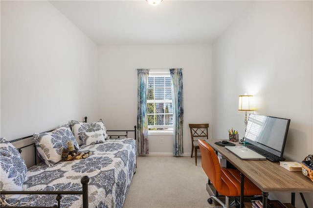 bedroom featuring light carpet and baseboards