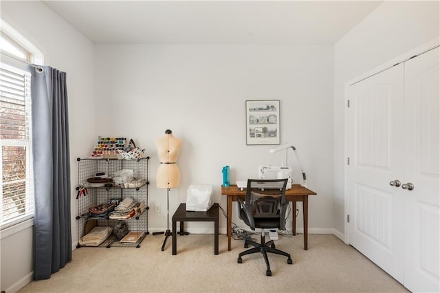 carpeted office space featuring baseboards