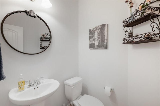 bathroom with toilet and a sink