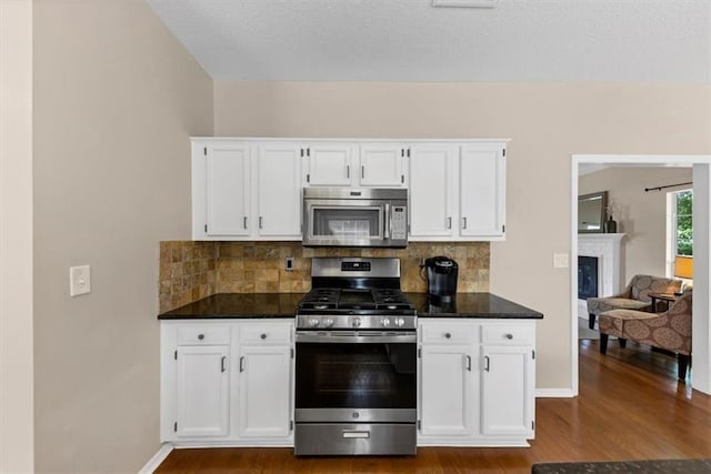 10535 Willow Meadow Cir, Alpharetta, GA 30022 - kitchen with stainless steel appliances, dark wood-style flooring, and white cabinets