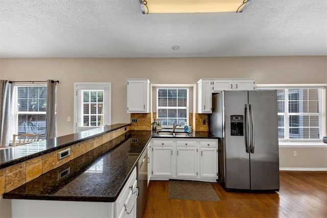10535 Willow Meadow Cir, Alpharetta, GA 30022 - kitchen with appliances with stainless steel finishes, dark wood-style flooring, a peninsula, white cabinets, and a textured ceiling