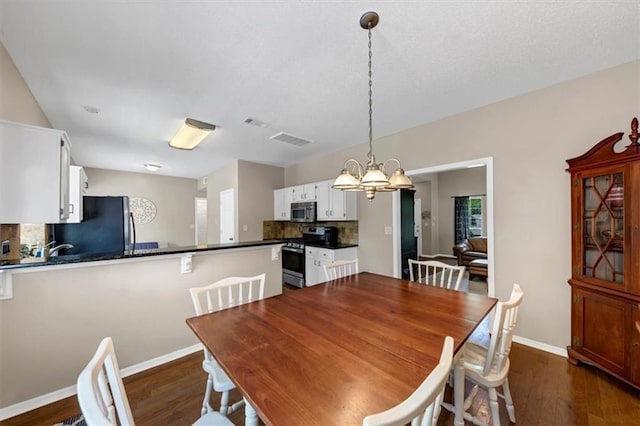 10535 Willow Meadow Cir, Alpharetta, GA 30022 - dining space with dark wood finished floors and a chandelier